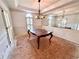 Dining room with decorative woodwork, an elegant chandelier, and natural light from large shuttered windows at 507 Cross Creek Pt, Stone Mountain, GA 30087
