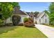 Well-manicured front yard with a white house and complementary stone masonry at 507 Cross Creek Pt, Stone Mountain, GA 30087