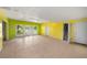 Bright living room with tile floors, multiple windows, and access to stairs and an exterior door at 507 Cross Creek Pt, Stone Mountain, GA 30087
