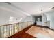A light-filled loft area showcasing the wood floors and railing at 507 Cross Creek Pt, Stone Mountain, GA 30087