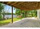 The covered patio has views of the lake and the lush greenery in the backyard at 507 Cross Creek Pt, Stone Mountain, GA 30087