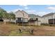 View of the back of the home, elevated deck, screened porch, and backyard fire pit at 113 Westchester Xing, Canton, GA 30115