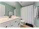 Bathroom features a vanity with a sink, mirror, and shower with white shower curtain at 113 Westchester Xing, Canton, GA 30115