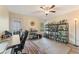 A bonus room featuring hardwood-style floors, ceiling fan, and liquor storage at 113 Westchester Xing, Canton, GA 30115