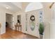 Bright foyer with hardwood floors, decorative front door, and elegant lighting at 113 Westchester Xing, Canton, GA 30115