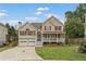 Charming two-story home with a welcoming front porch, attached two-car garage, and landscaped yard at 113 Westchester Xing, Canton, GA 30115