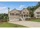 Two-story home with a welcoming front porch, attached two-car garage, and landscaped yard at 113 Westchester Xing, Canton, GA 30115