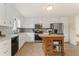 Charming kitchen featuring white cabinets, stainless steel appliances, and a movable wood island at 113 Westchester Xing, Canton, GA 30115
