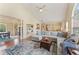 Open-concept living room with ample seating, neutral decor, and hardwood flooring at 113 Westchester Xing, Canton, GA 30115