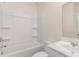 Bright bathroom featuring a vanity with sink, mirror, and a shower-tub combination at 1149 Blue Juniper Cir, Loganville, GA 30052