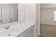 The bathroom has a white vanity, faucet, and a framed mirror at 1149 Blue Juniper Cir, Loganville, GA 30052