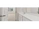 Bathroom boasts a white vanity with framed mirror and views to the bedroom at 1149 Blue Juniper Cir, Loganville, GA 30052