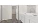 Bright bathroom with double sinks and gray wood-look tile flooring at 1149 Blue Juniper Cir, Loganville, GA 30052