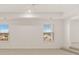 Large room with two windows offering neighborhood views and neutral carpet at 1149 Blue Juniper Cir, Loganville, GA 30052