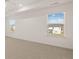 Bedroom with two windows offering neighborhood views and carpeted flooring at 1149 Blue Juniper Cir, Loganville, GA 30052