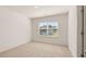 Bedroom with neutral carpet, window with blinds, and ample natural light at 1149 Blue Juniper Cir, Loganville, GA 30052