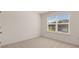 Bedroom with large window and neutral carpeting at 1149 Blue Juniper Cir, Loganville, GA 30052