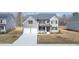 Charming two-story home with a two car garage, manicured lawn, and a symmetrical design at 1149 Blue Juniper Cir, Loganville, GA 30052