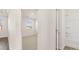 Hallway view of neutral bedroom with a window and an ensuite bathroom with tub and shower at 1149 Blue Juniper Cir, Loganville, GA 30052