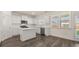 Bright kitchen with an island, stainless steel appliances, white cabinets, and hard surface floors at 1149 Blue Juniper Cir, Loganville, GA 30052