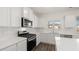 Beautiful kitchen with modern stainless steel appliances, white cabinets, and subway tile backsplash at 1149 Blue Juniper Cir, Loganville, GA 30052