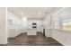 Open kitchen featuring white cabinets, stainless steel appliances, an island, and hard surface flooring at 1149 Blue Juniper Cir, Loganville, GA 30052