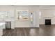 Living Room view with stainless steel dishwasher, backyard access, open floor plan and fireplace at 1149 Blue Juniper Cir, Loganville, GA 30052