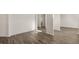 Spacious living room with hard surface floors, bright white walls and baseboards, creating a modern design at 1149 Blue Juniper Cir, Loganville, GA 30052
