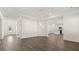 Spacious living room with hardwood floors flowing into a modern kitchen with white cabinetry at 1149 Blue Juniper Cir, Loganville, GA 30052