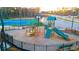 Community playground with slides, climbing structures, and a fenced perimeter at 1149 Blue Juniper Cir, Loganville, GA 30052