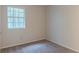 Neutral carpeted bedroom with one window featuring ample natural light and neutral paint at 4634 Garden Hills Dr, Stone Mountain, GA 30083