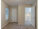 Neutral bedroom with carpet, window, and access to the hallway at 4634 Garden Hills Dr, Stone Mountain, GA 30083