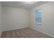 A simple bedroom with carpet and a window overlooking trees at 4634 Garden Hills Dr, Stone Mountain, GA 30083