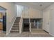Welcoming foyer with staircase, neutral carpet, and paint, providing access to kitchen and living spaces at 4634 Garden Hills Dr, Stone Mountain, GA 30083