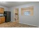 Open-concept kitchen with black appliances, wood cabinets, and a view to the staircase at 4634 Garden Hills Dr, Stone Mountain, GA 30083