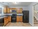 Kitchen features wood cabinets, black appliances, neutral countertops, and ample lighting at 4634 Garden Hills Dr, Stone Mountain, GA 30083