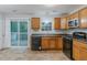 Functional kitchen with wood cabinets, black appliances, a sliding door to a deck, and neutral countertops at 4634 Garden Hills Dr, Stone Mountain, GA 30083