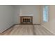 Cozy living room featuring a brick fireplace with a white mantel, neutral walls, and carpet at 4634 Garden Hills Dr, Stone Mountain, GA 30083