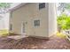 Exterior view of a two-story home featuring vinyl siding and a small backyard at 7070 Ravenwood Ln, Lithonia, GA 30038