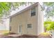 Exterior view of a two-story home featuring vinyl siding and a small backyard at 7070 Ravenwood Ln, Lithonia, GA 30038