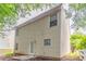 Exterior view of a two-story home featuring vinyl siding and a small backyard at 7070 Ravenwood Ln, Lithonia, GA 30038
