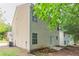 Exterior view of a two-story home featuring vinyl siding and a small backyard at 7070 Ravenwood Ln, Lithonia, GA 30038
