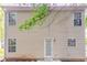 Exterior view of a two-story home featuring vinyl siding and a small backyard at 7070 Ravenwood Ln, Lithonia, GA 30038