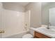 Bathroom features a tub and shower combination with a vanity and mirror at 7070 Ravenwood Ln, Lithonia, GA 30038