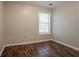Bedroom with dark wood floors and a window allowing natural light at 7070 Ravenwood Ln, Lithonia, GA 30038