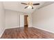 Bedroom with an open door, hardwood floors and fan at 7070 Ravenwood Ln, Lithonia, GA 30038