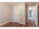 Bedroom with dark wood floors and entry to the garage at 7070 Ravenwood Ln, Lithonia, GA 30038