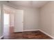 Bedroom with dark wood floors and view to the attic at 7070 Ravenwood Ln, Lithonia, GA 30038