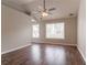 Bedroom with two windows, hard wood floors and fan at 7070 Ravenwood Ln, Lithonia, GA 30038