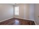 This bedroom features wood floors and a window for natural light at 7070 Ravenwood Ln, Lithonia, GA 30038